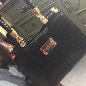 selling black medium bebe hand bag.